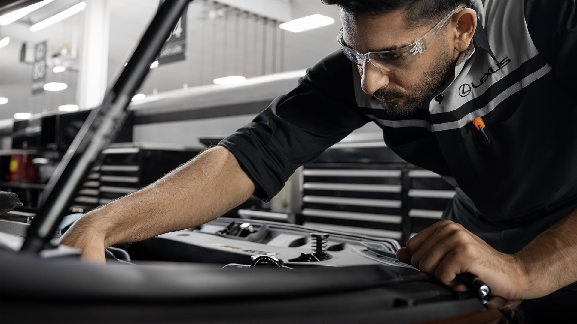 A mechanic works on a Lexus vehicle